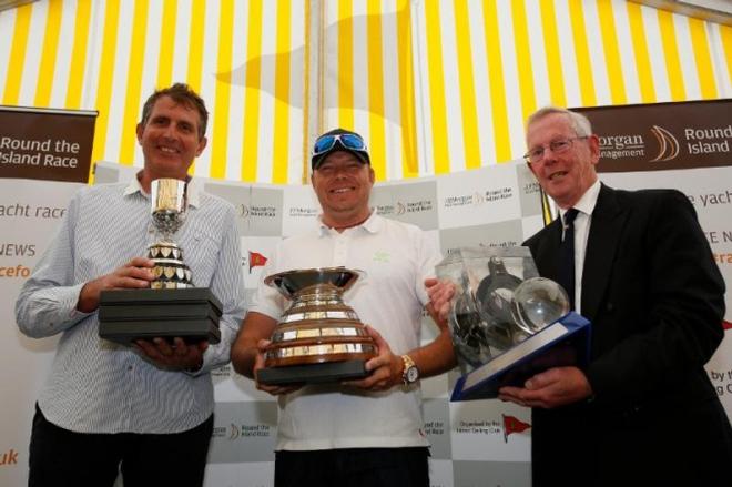 Lloyd Thornburg (centre) and his co-helm Brian Thompson (left) are pictured with Rear Commodore Peter Bingham and their fantastic collection of trophies after their stunning and record-breaking Race on Phaedo^3. - 2016 J.P. Morgan Asset Management Round the Island Race © Patrick Eden